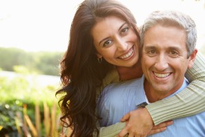 husband and wife embracing outside and smiling